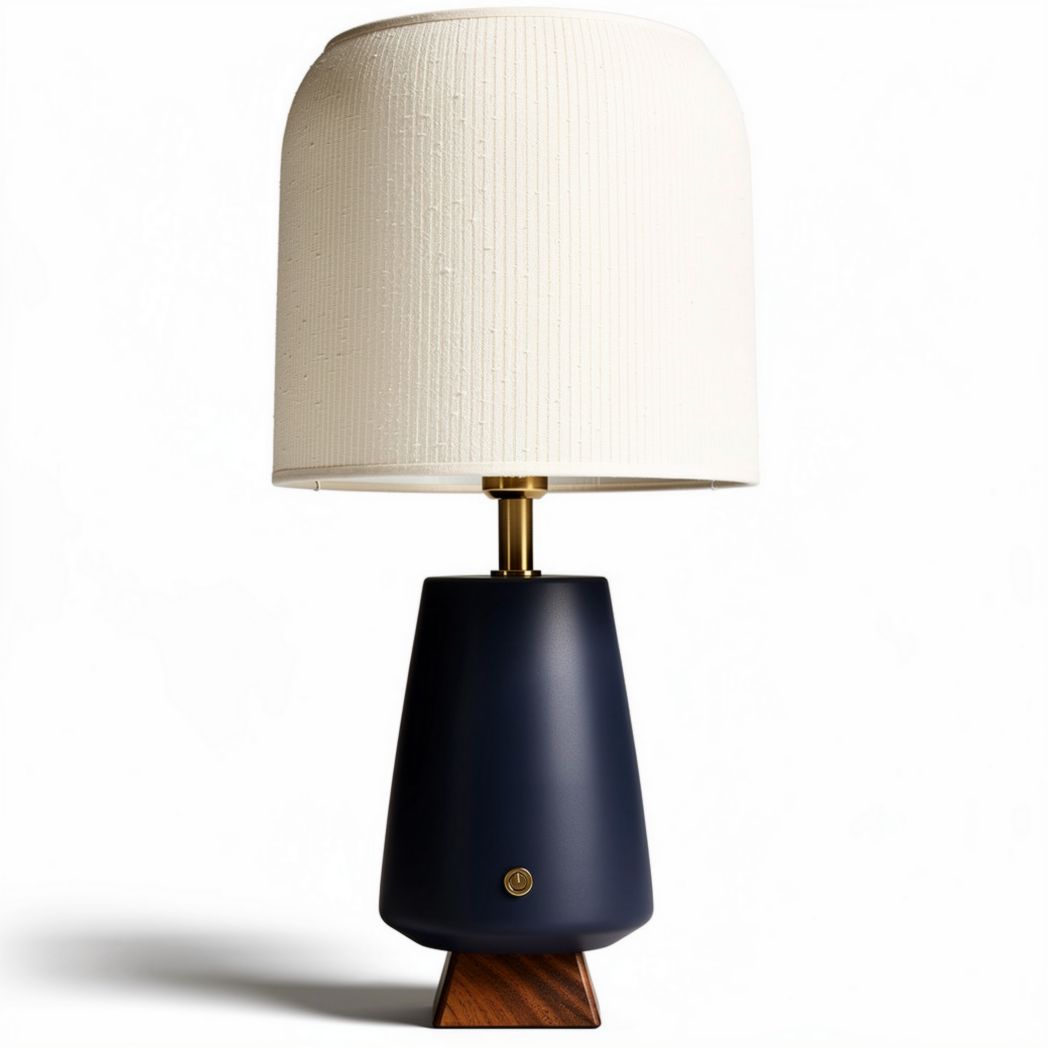 Navy blue ceramic table lamp with white fabric shade and wooden base